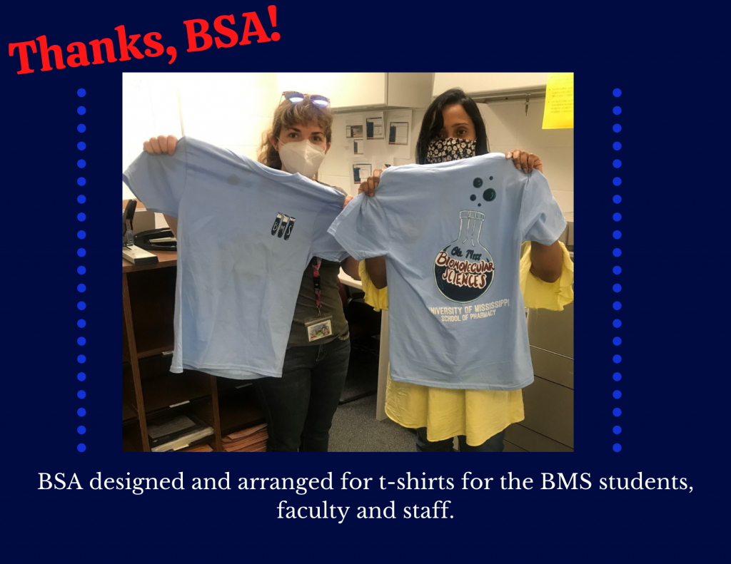 Picture of 2 people holding t shirts, thanking the BSA organization for designing and arranging t shirts